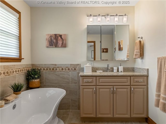 53 Wildrose Ln, Scott Depot, WV 25560 - bathroom with a soaking tub, vanity, and tile walls
