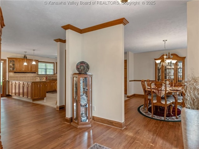 53 Wildrose Ln, Scott Depot, WV 25560 - hall with wood finished floors, a chandelier, and crown molding