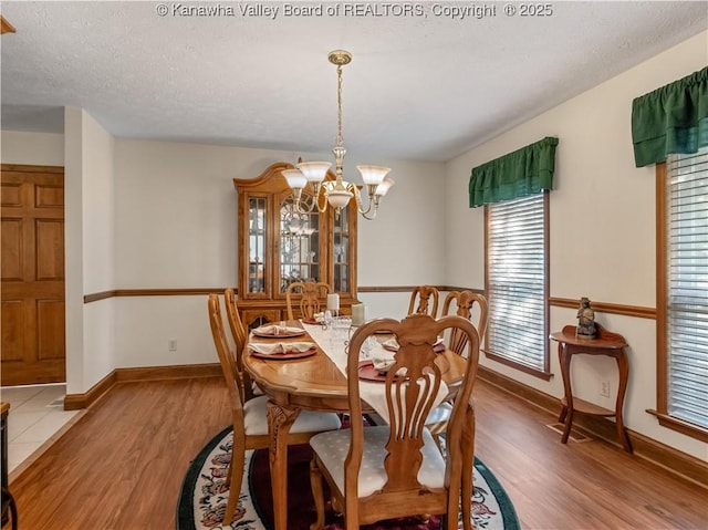 53 Wildrose Ln, Scott Depot, WV 25560 - dining area with light wood-style floors, a chandelier, and a textured ceiling