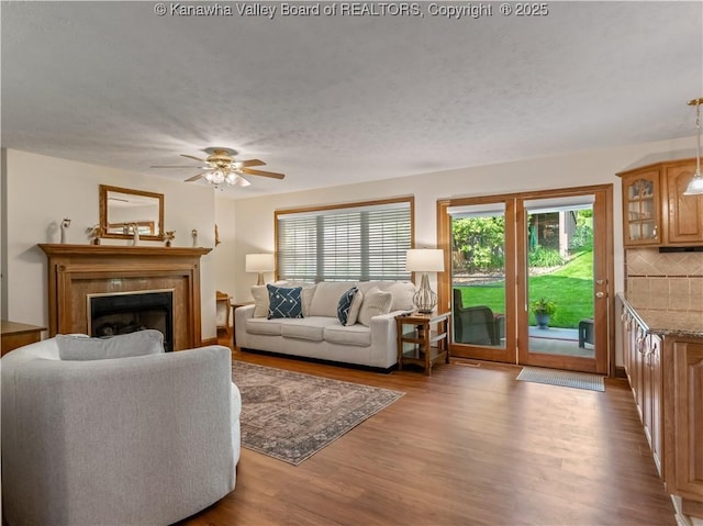 53 Wildrose Ln, Scott Depot, WV 25560 - living room featuring wood finished floors, a textured ceiling, ceiling fan, and a fireplace