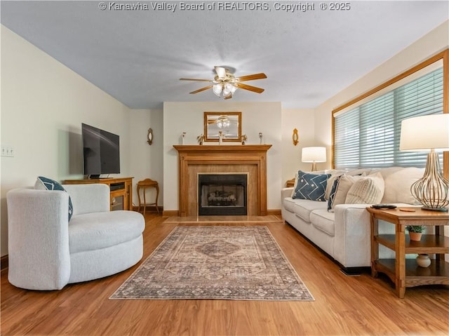 53 Wildrose Ln, Scott Depot, WV 25560 - living room featuring wood finished floors, a ceiling fan, and a tile fireplace