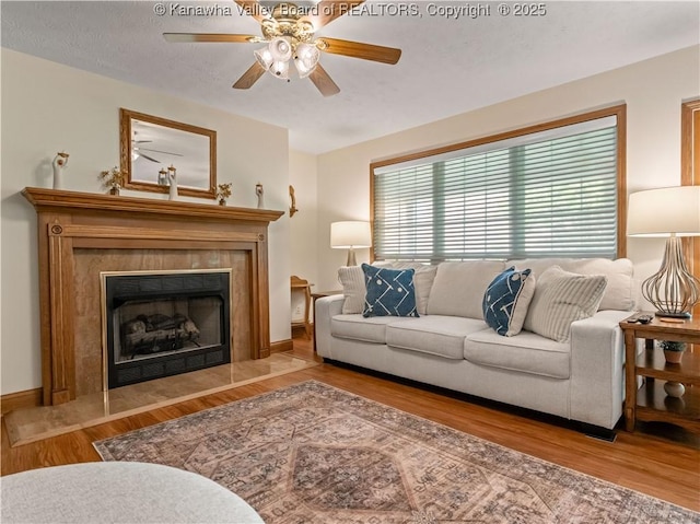 53 Wildrose Ln, Scott Depot, WV 25560 - living room featuring wood finished floors, ceiling fan, and a tiled fireplace