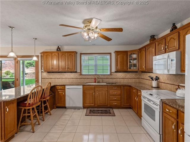 53 Wildrose Ln, Scott Depot, WV 25560 - kitchen featuring white appliances, brown cabinetry, a peninsula, dark stone counters, and a ceiling fan