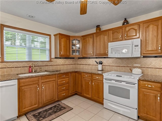 53 Wildrose Ln, Scott Depot, WV 25560 - kitchen with white appliances, brown cabinets, light stone counters, light tile patterned floors, and decorative backsplash