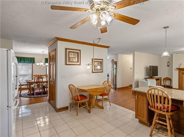 53 Wildrose Ln, Scott Depot, WV 25560 - dining room featuring light tile patterned flooring, a textured ceiling, a ceiling fan, and a chandelier