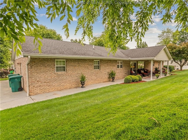 53 Wildrose Ln, Scott Depot, WV 25560 - rear view of property featuring brick siding, a yard, a patio, and an outdoor living space