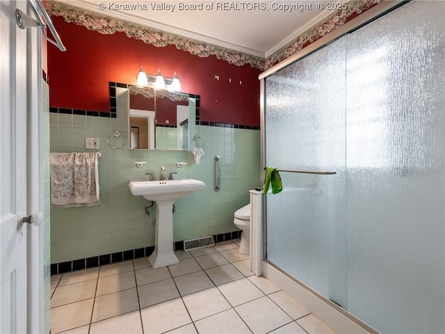 412 C St, Saint Albans, WV 25177 - bathroom featuring a shower stall, tile walls, tile patterned flooring, and ornamental molding