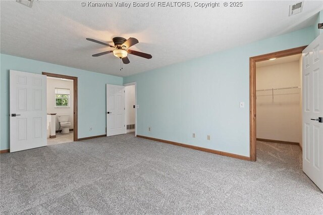 1571 Thistlewood Cir, Hurricane, WV 25526 - unfurnished bedroom featuring carpet, a walk in closet, connected bathroom, a ceiling fan, and a closet