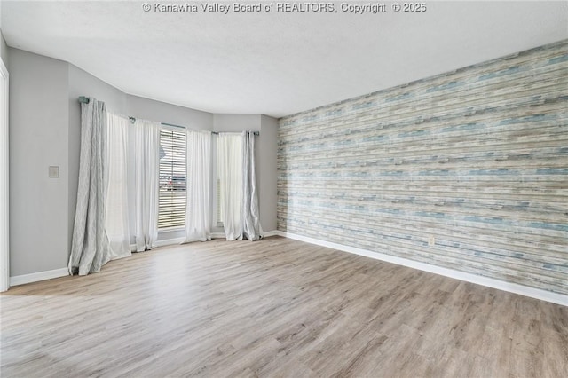 1571 Thistlewood Cir, Hurricane, WV 25526 - unfurnished room with an accent wall, wallpapered walls, and wood finished floors