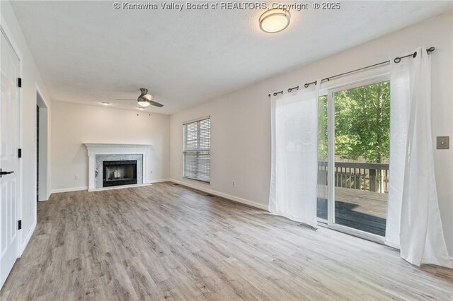 1571 Thistlewood Cir, Hurricane, WV 25526 - unfurnished living room with a ceiling fan, wood finished floors, and a high end fireplace