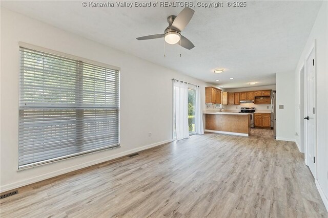 1571 Thistlewood Cir, Hurricane, WV 25526 - unfurnished living room with light wood-style flooring and ceiling fan