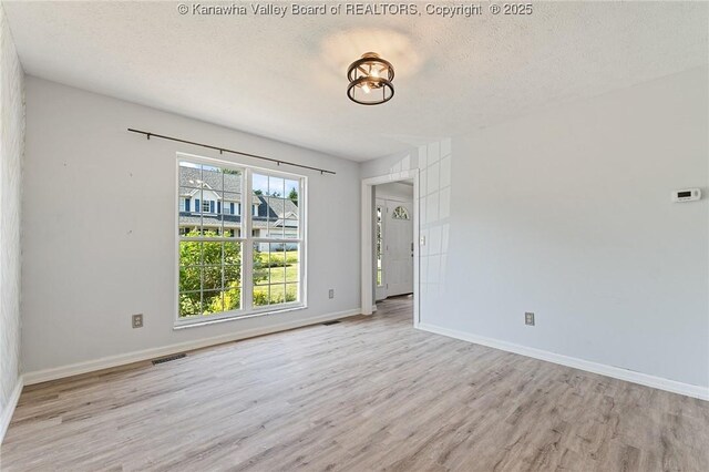1571 Thistlewood Cir, Hurricane, WV 25526 - unfurnished room with light wood-style flooring and a textured ceiling