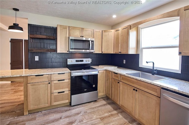 911 Dupont Ave, Nitro, WV 25143 - kitchen with stainless steel appliances, light brown cabinetry, open shelves, backsplash, and light wood-style floors