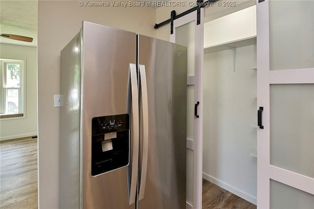 911 Dupont Ave, Nitro, WV 25143 - kitchen featuring stainless steel fridge, wood finished floors, and a barn door
