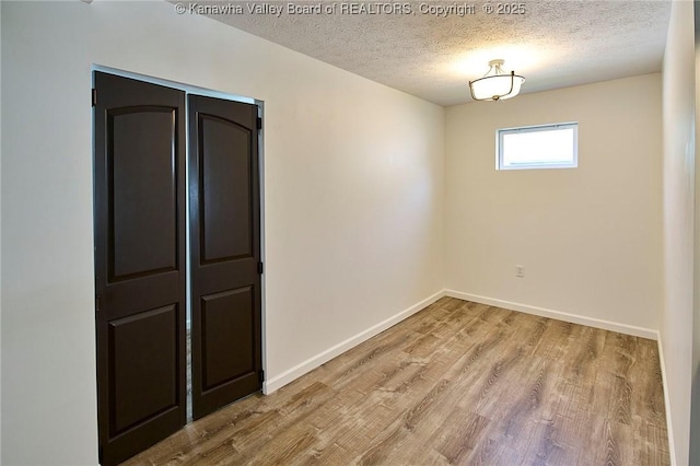 911 Dupont Ave, Nitro, WV 25143 - empty room with wood finished floors and a textured ceiling