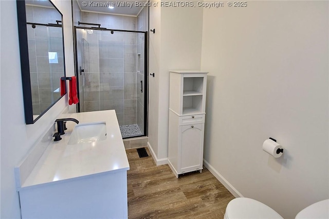 911 Dupont Ave, Nitro, WV 25143 - bathroom with wood finished floors, a shower stall, vanity, and recessed lighting