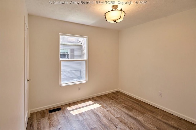 911 Dupont Ave, Nitro, WV 25143 - unfurnished room with wood finished floors and a textured ceiling