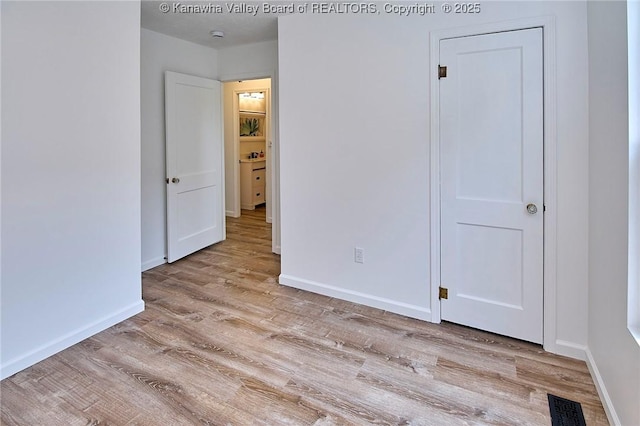 911 Dupont Ave, Nitro, WV 25143 - unfurnished bedroom with wood finished floors and baseboards