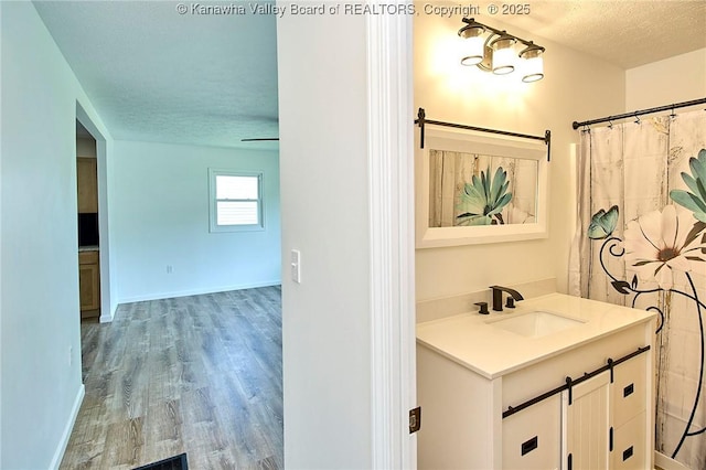 911 Dupont Ave, Nitro, WV 25143 - bathroom with vanity, wood finished floors, and a textured ceiling