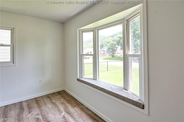 911 Dupont Ave, Nitro, WV 25143 - spare room with wood finished floors and baseboards
