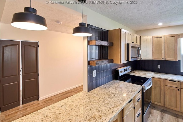 911 Dupont Ave, Nitro, WV 25143 - kitchen featuring stainless steel appliances, a textured ceiling, light wood-style floors, backsplash, and light stone counters