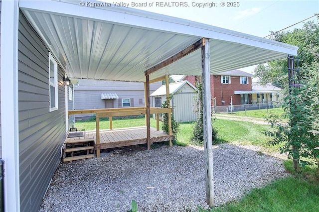 911 Dupont Ave, Nitro, WV 25143 - view of patio with a wooden deck, a storage shed, and a carport