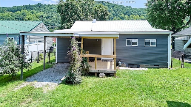 911 Dupont Ave, Nitro, WV 25143 - rear view of house with crawl space, gravel driveway, a metal roof, and a wooden deck
