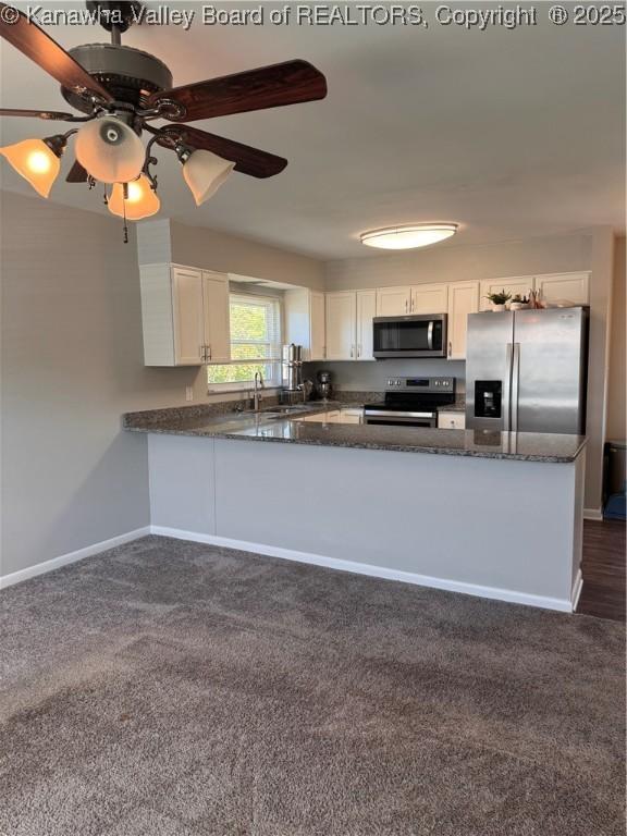 3007 Sansom Ct, Milton, WV 25541 - kitchen featuring appliances with stainless steel finishes, white cabinets, a peninsula, dark stone countertops, and ceiling fan