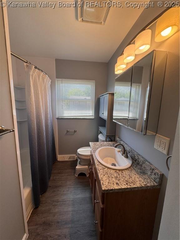 3007 Sansom Ct, Milton, WV 25541 - bathroom with wood finished floors, plenty of natural light, vanity, and shower / tub combo with curtain