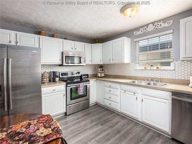 732 Jordan Pl, Nitro, WV 25143 - kitchen featuring stainless steel appliances, white cabinetry, light countertops, and a textured ceiling