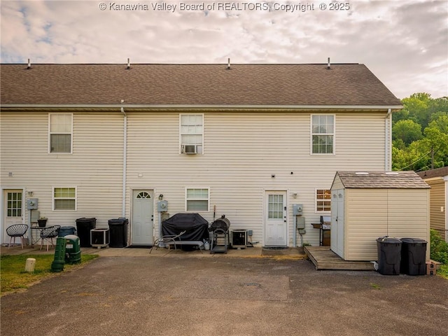 732 Jordan Pl, Nitro, WV 25143 - back of property with a shed, cooling unit, and a shingled roof
