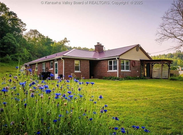 15 Eagle Flight Rd, Ripley, WV 25271 - rear view of property featuring brick siding, a yard, a chimney, and a metal roof