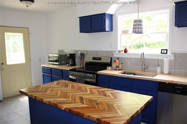 1840-A Oakridge Dr, Charleston, WV 25311 - kitchen featuring blue cabinets, stainless steel appliances, wooden counters, tasteful backsplash, and light tile patterned floors