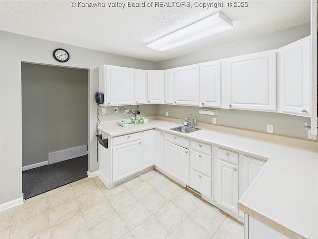 319 Main St, Clay, WV 25043 - kitchen featuring white cabinetry, a textured ceiling, and light countertops