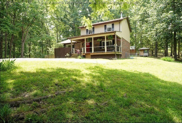 690 Rambling Hills Rd, Elkview, WV 25071 - rear view of property with covered porch, a yard, and brick siding