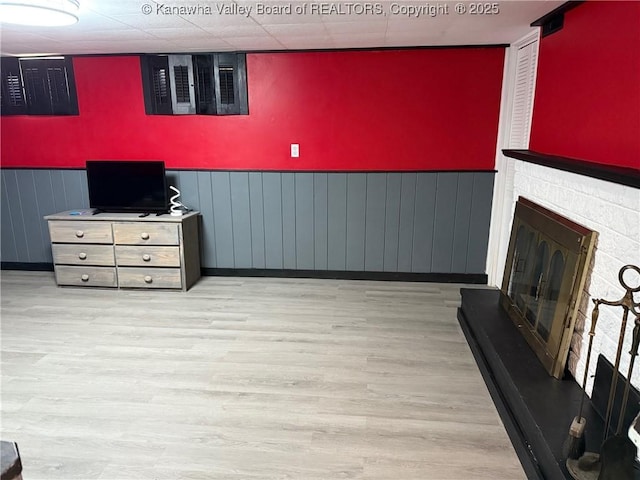 1524 Fenton Cir, Nitro, WV 25143 - living room with wood finished floors, a stone fireplace, and wainscoting