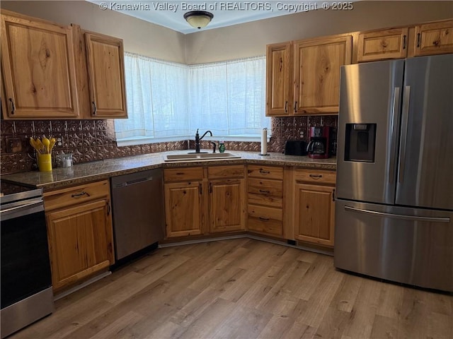 1524 Fenton Cir, Nitro, WV 25143 - kitchen with stainless steel appliances, dark countertops, light wood-type flooring, decorative backsplash, and brown cabinets