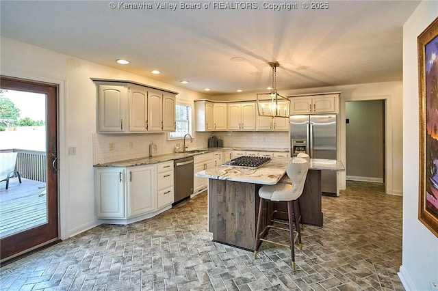 1004 Wethersfield Xing, Hurricane, WV 25526 - kitchen featuring stainless steel appliances, backsplash, light stone counters, a kitchen bar, and recessed lighting