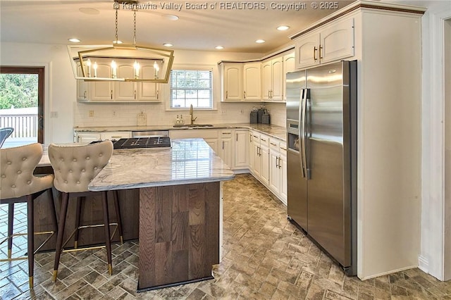 1004 Wethersfield Xing, Hurricane, WV 25526 - kitchen featuring stainless steel fridge, a kitchen island, backsplash, recessed lighting, and pendant lighting