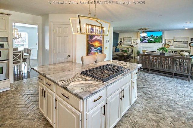 1004 Wethersfield Xing, Hurricane, WV 25526 - kitchen featuring a chandelier, appliances with stainless steel finishes, light stone counters, a center island, and open floor plan