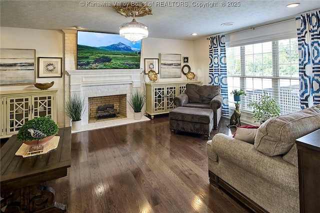 1004 Wethersfield Xing, Hurricane, WV 25526 - living room with a textured ceiling, wood finished floors, and a brick fireplace