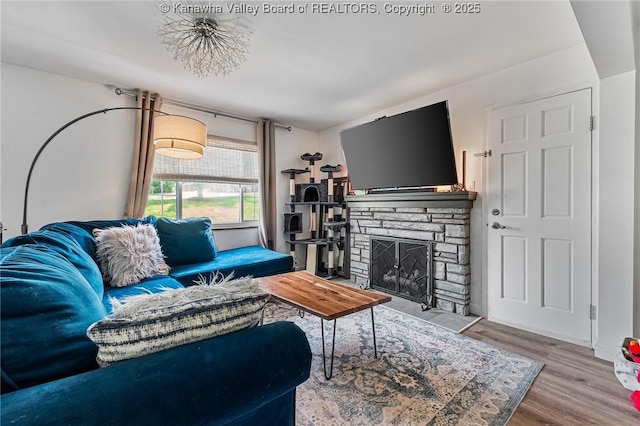 916 Amherst Dr, Charleston, WV 25302 - living room featuring a stone fireplace and wood finished floors