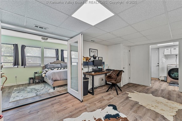 916 Amherst Dr, Charleston, WV 25302 - bedroom featuring washer / clothes dryer, a desk, a drop ceiling, and wood finished floors