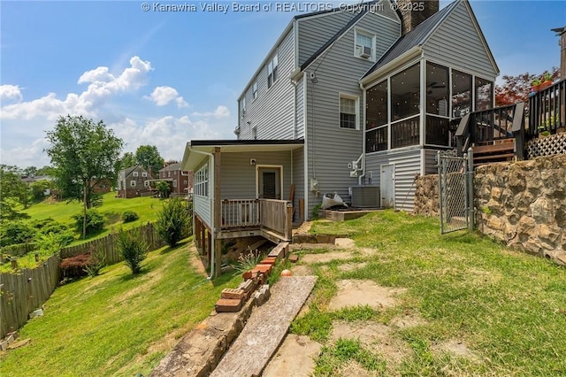 916 Amherst Dr, Charleston, WV 25302 - rear view of property featuring a sunroom, a fenced backyard, a deck, and a chimney