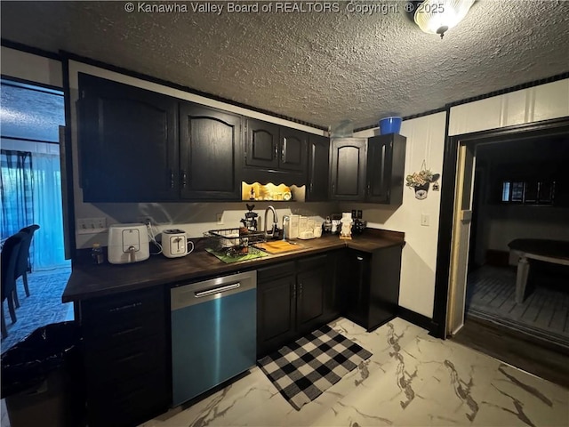 969 Airport Rd, Chapmanville, WV 25508 - kitchen with dishwashing machine, light marble finish floors, a textured ceiling, and dark cabinets
