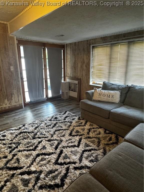 969 Airport Rd, Chapmanville, WV 25508 - living area with healthy amount of natural light, wooden walls, and wood finished floors