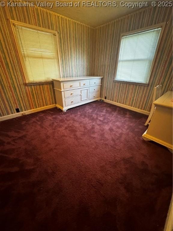 969 Airport Rd, Chapmanville, WV 25508 - spare room with wallpapered walls and dark carpet