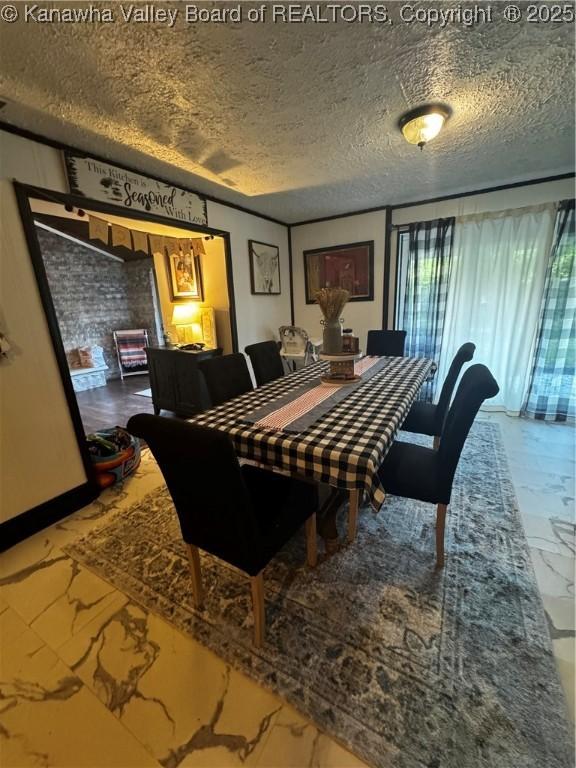 969 Airport Rd, Chapmanville, WV 25508 - dining room featuring a textured ceiling and marble finish floors