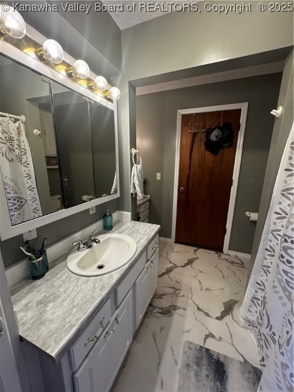 969 Airport Rd, Chapmanville, WV 25508 - full bath featuring vanity and marble look tile flooring