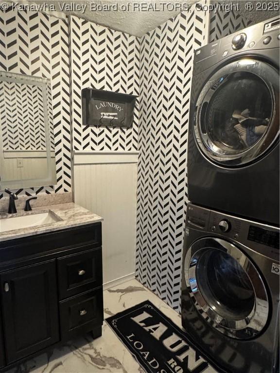 969 Airport Rd, Chapmanville, WV 25508 - laundry area featuring stacked washer / drying machine and light marble finish floors